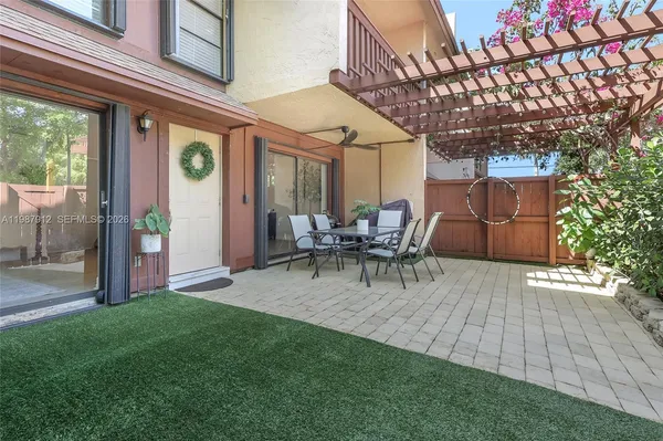 a view of a patio with table and chairs