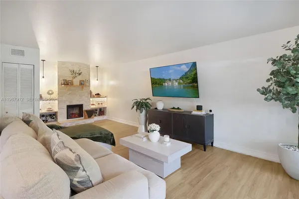 a living room with furniture and a flat screen tv