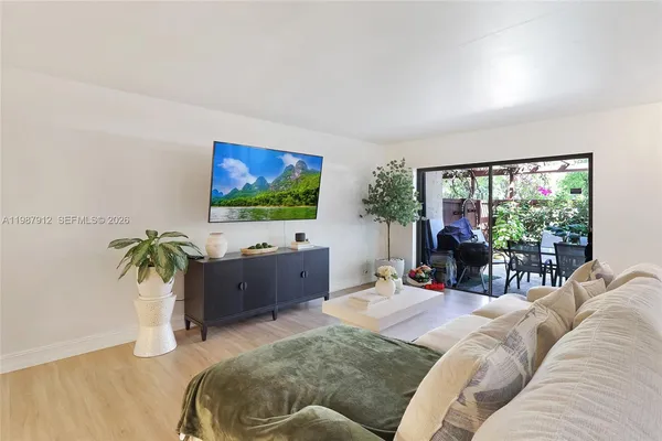 a living room with furniture and a flat screen tv