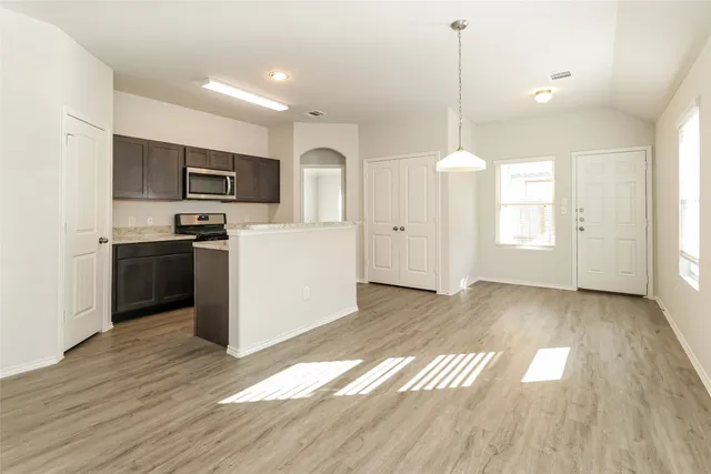 a view of kitchen with sink microwave and refrigerator