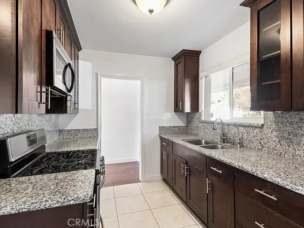 a kitchen with a sink stove and refrigerator