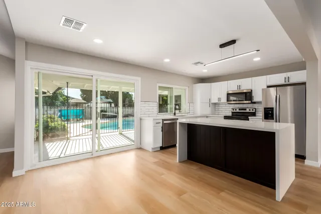 a view of an empty room with glass door and a window