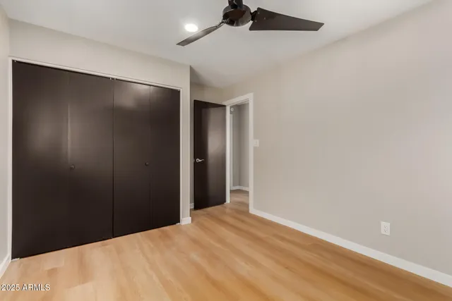 a view of a room with a window and a ceiling fan