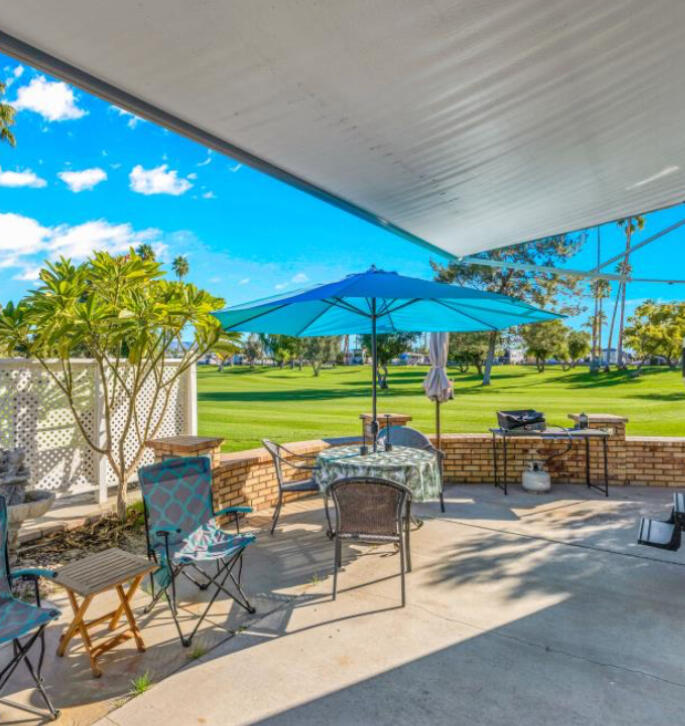 69411 Ramon Road, Unit 776 Cathedral City, CA 92234 - Photo 2 of 17 a patio with glass top table and chairs