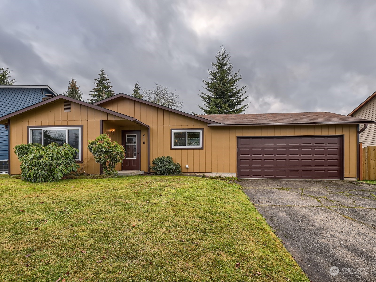 416 213th Street Southwest Bothell, WA 98021 - Photo 1 of 12 a view of a house with a yard and garage