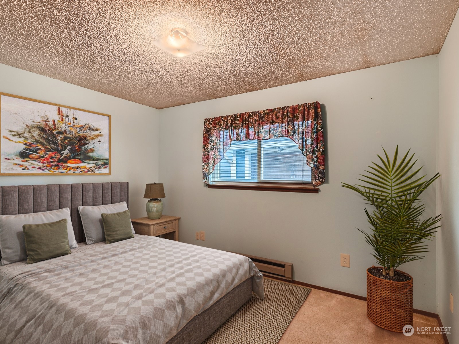 416 213th Street Southwest Bothell, WA 98021 - Photo 10 of 12 a bedroom with a bed and a painting on the wall
