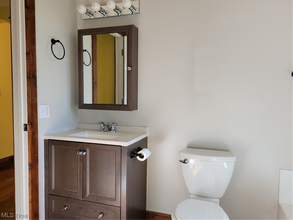 22922 Putney Ridge Road Quaker City, OH 43773 - Photo 21 of 31 Bathroom featuring large vanity, mirror, and hardwood flooring