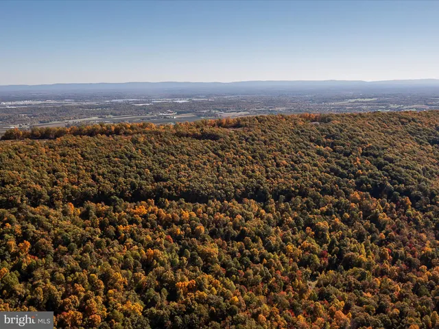 a view of a large mountain with mountains in the background