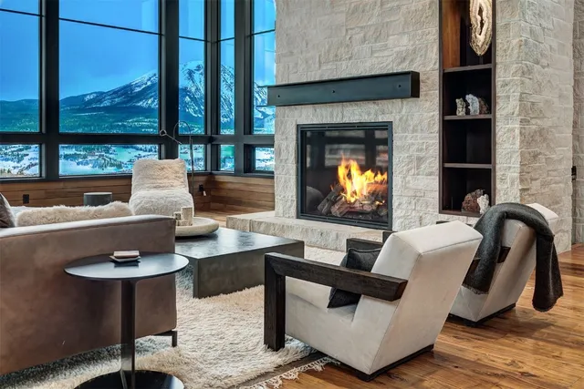 a living room with fireplace furniture and a floor to ceiling window