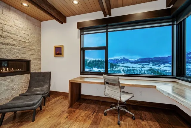 a living room with a large window and furniture