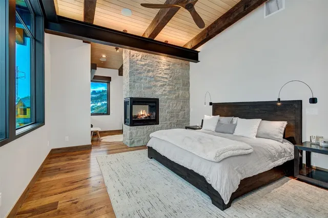 a spacious bedroom with a bed and a fireplace