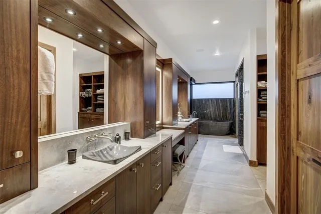 a large bathroom with a large mirror vanity and a shower