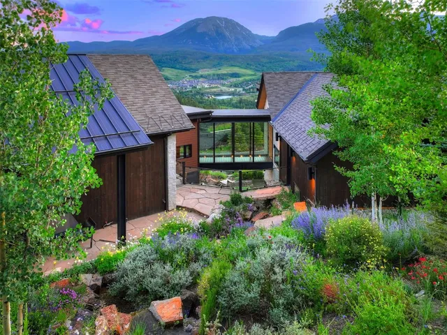 a front view of a house with a yard and potted plants