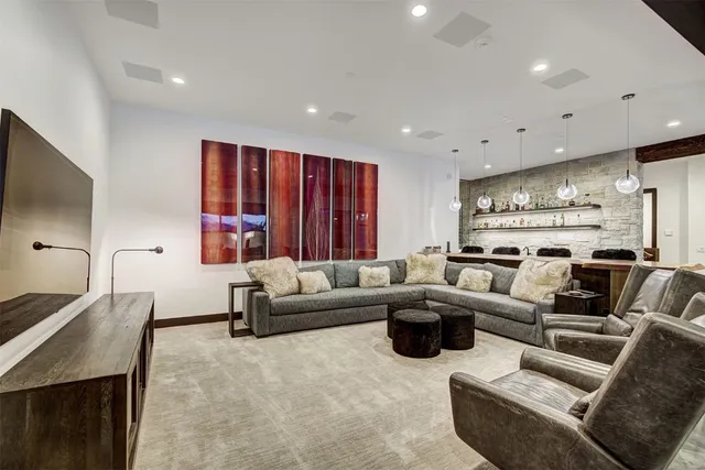 a living room with furniture wooden floor and a large window