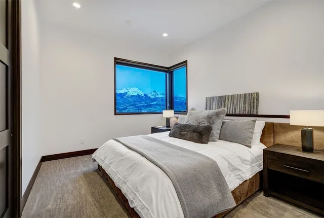 a bathroom with a granite countertop sink a mirror and a toilet