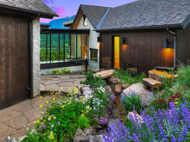 a view of a chair and table in the patio in front of house