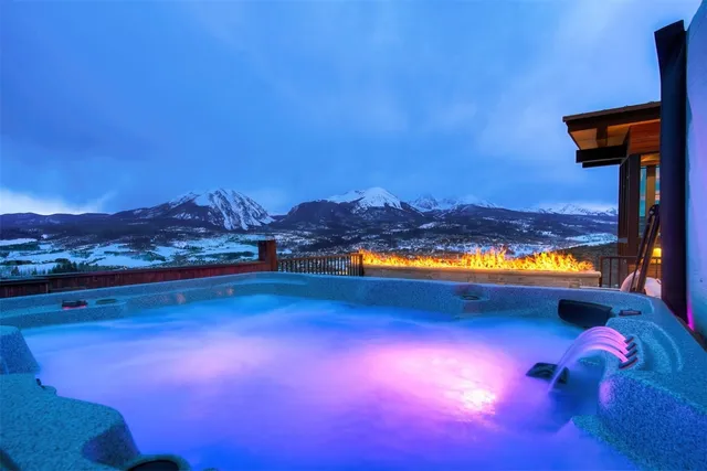 a aerial view of multiple houses with a lake