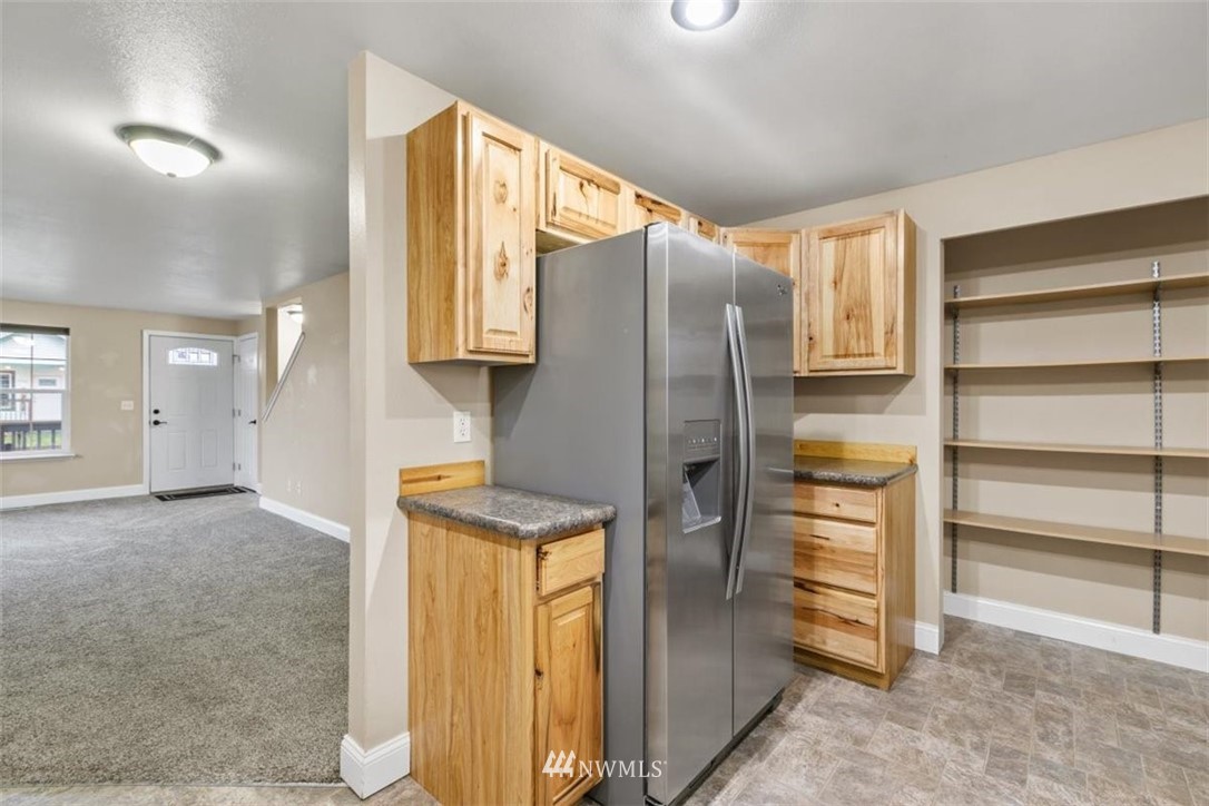 17923 Charlotte Place Southwest Rochester, WA 98579 - Photo 12 of 24 a kitchen with stainless steel appliances granite countertop a refrigerator and a sink