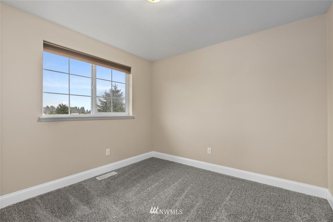 17923 Charlotte Place Southwest Rochester, WA 98579 - Photo 16 of 24 an empty room with windows