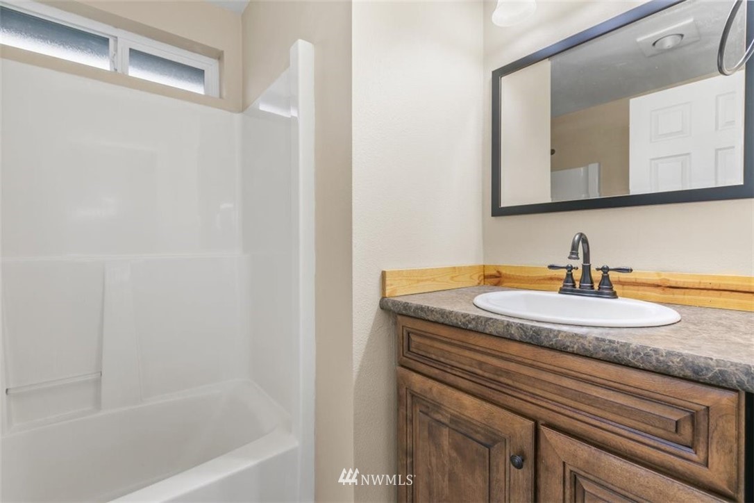 17923 Charlotte Place Southwest Rochester, WA 98579 - Photo 17 of 24 a bathroom with a sink and a mirror