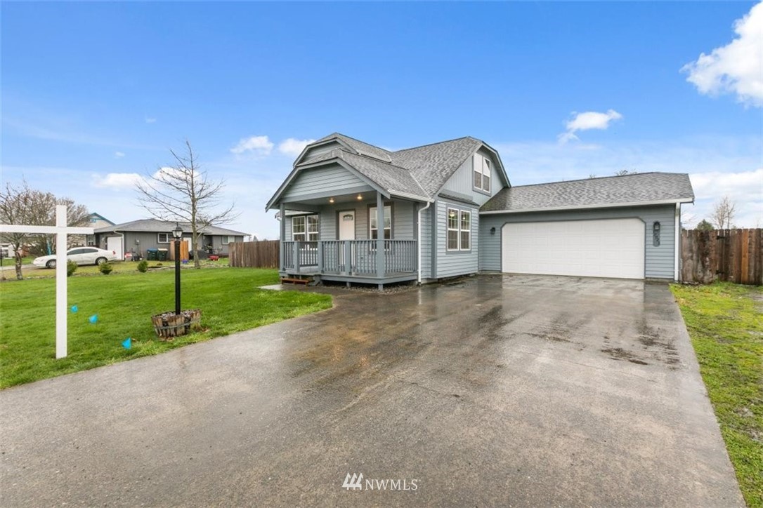 17923 Charlotte Place Southwest Rochester, WA 98579 - Photo 4 of 24 a front view of a house with a yard and garage