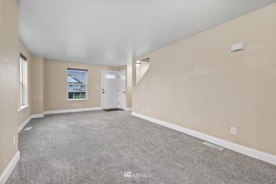 17923 Charlotte Place Southwest Rochester, WA 98579 - Photo 7 of 24 an empty room with a empty space and windows