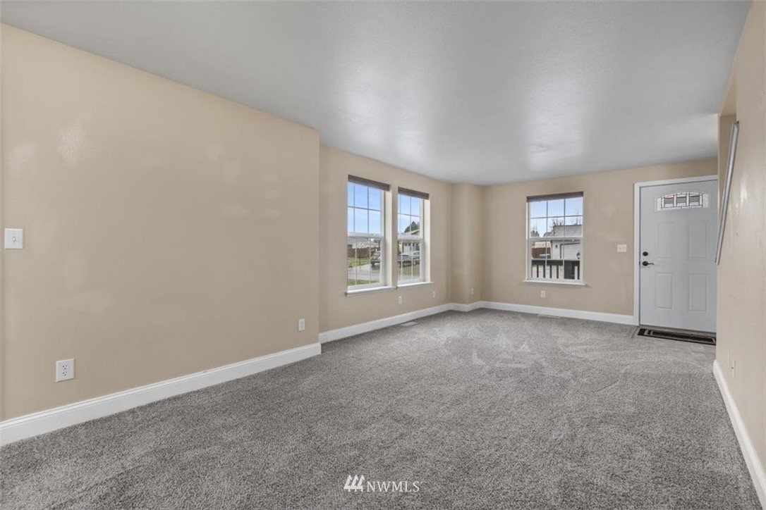 17923 Charlotte Place Southwest Rochester, WA 98579 - Photo 8 of 24 an empty room with windows and cabinet