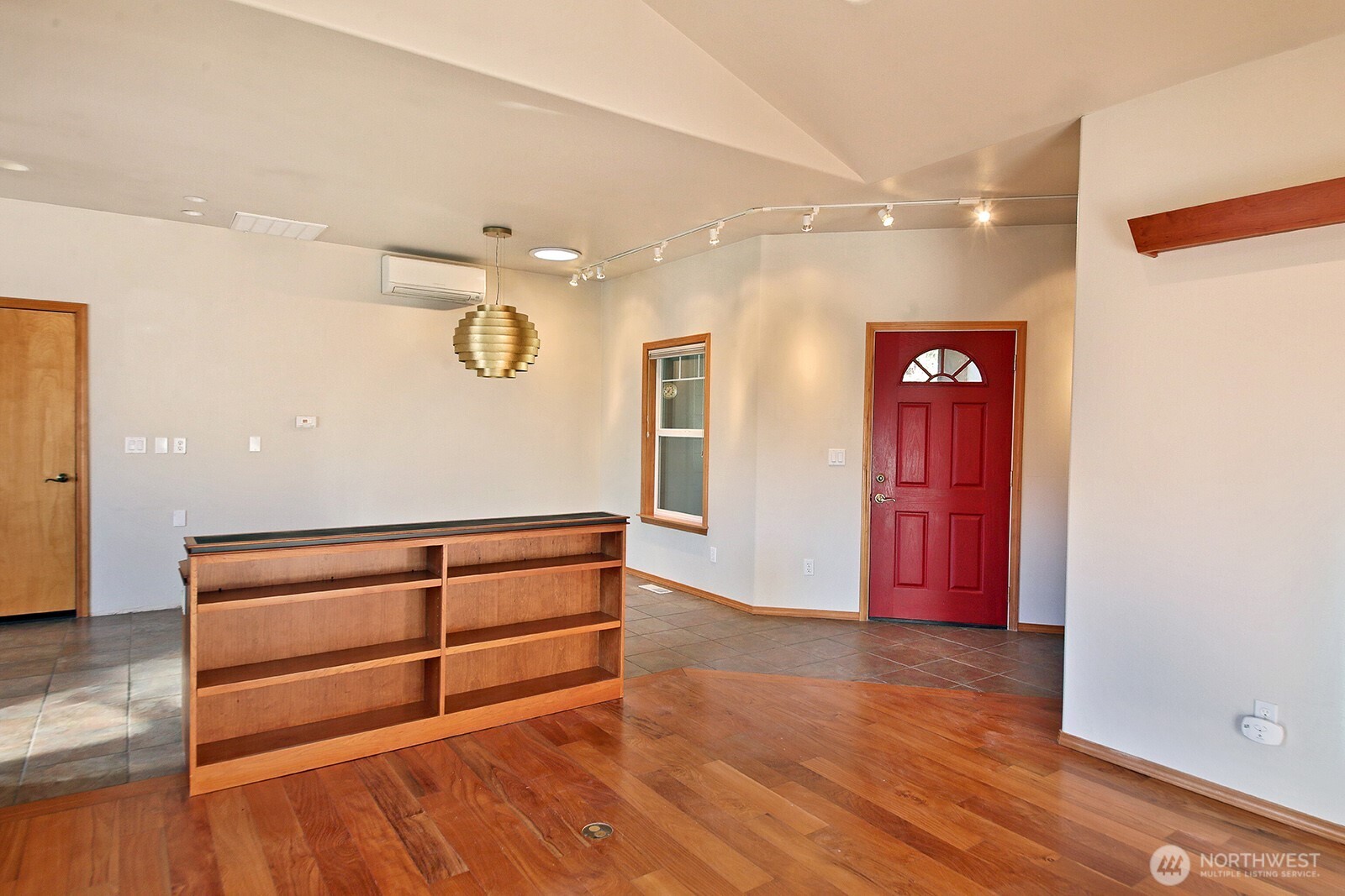 1752 Lee Court, Unit 5 Freeland, WA 98249 - Photo 16 of 38 a view of an empty room with wooden floor and cabinet