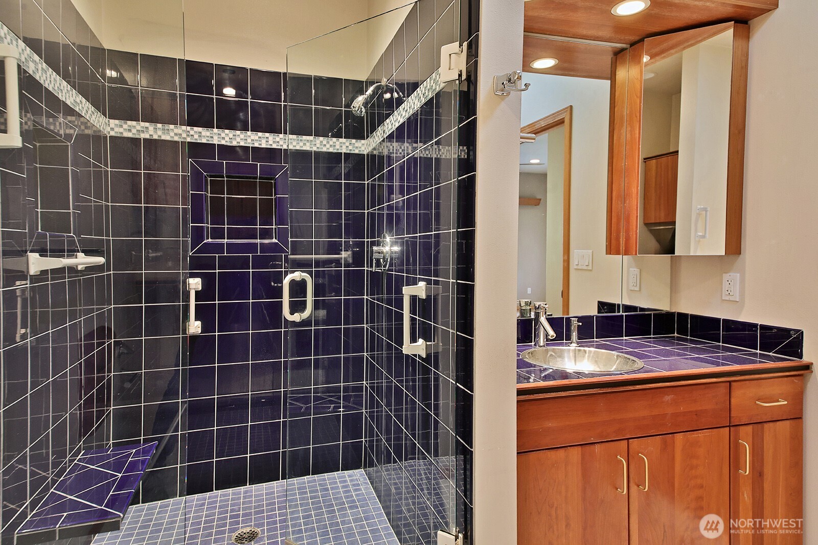 1752 Lee Court, Unit 5 Freeland, WA 98249 - Photo 29 of 38 a bathroom with a sink a shower and a mirror