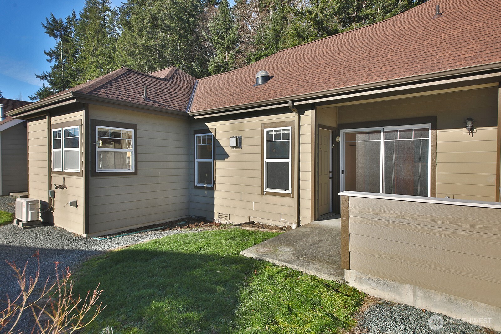 1752 Lee Court, Unit 5 Freeland, WA 98249 - Photo 7 of 38 a front view of a house with a yard