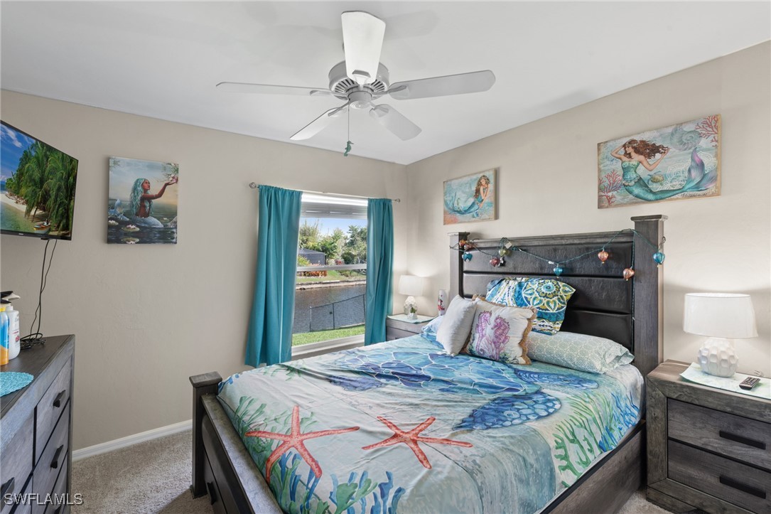 3307 Southwest 2nd Avenue Cape Coral, FL 33914 - Photo 20 of 39 a bedroom with a bed and a chandelier