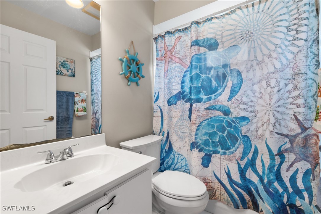 3307 Southwest 2nd Avenue Cape Coral, FL 33914 - Photo 22 of 39 a bathroom with a toilet sink and mirror