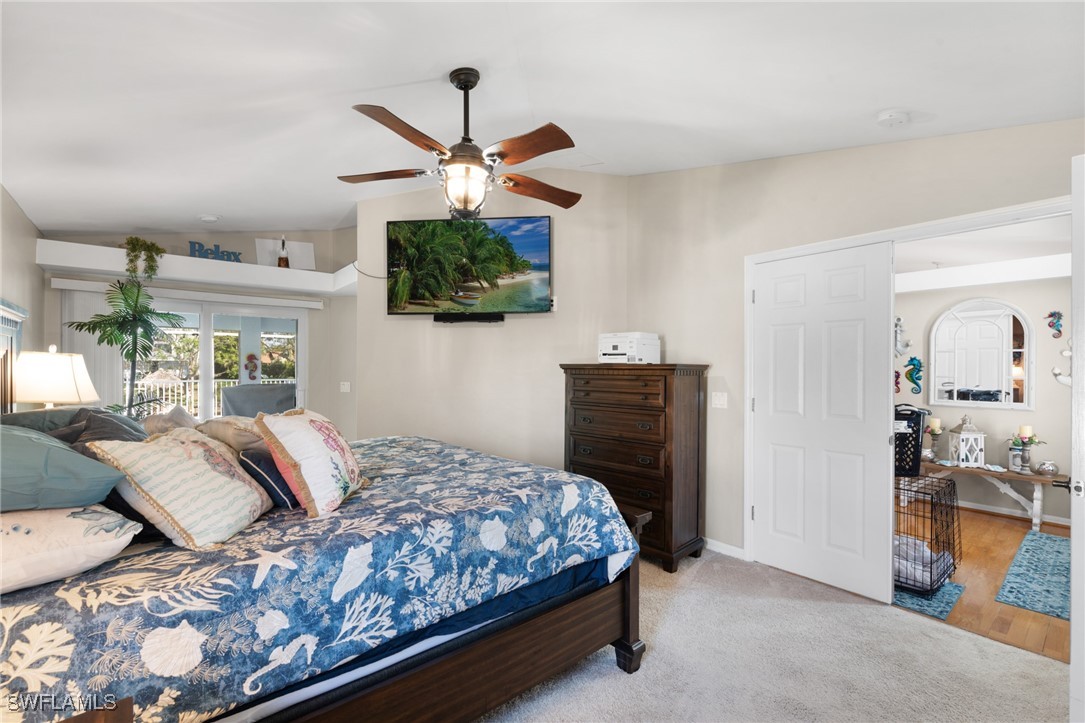 3307 Southwest 2nd Avenue Cape Coral, FL 33914 - Photo 24 of 39 a bedroom with a bed and a chandelier