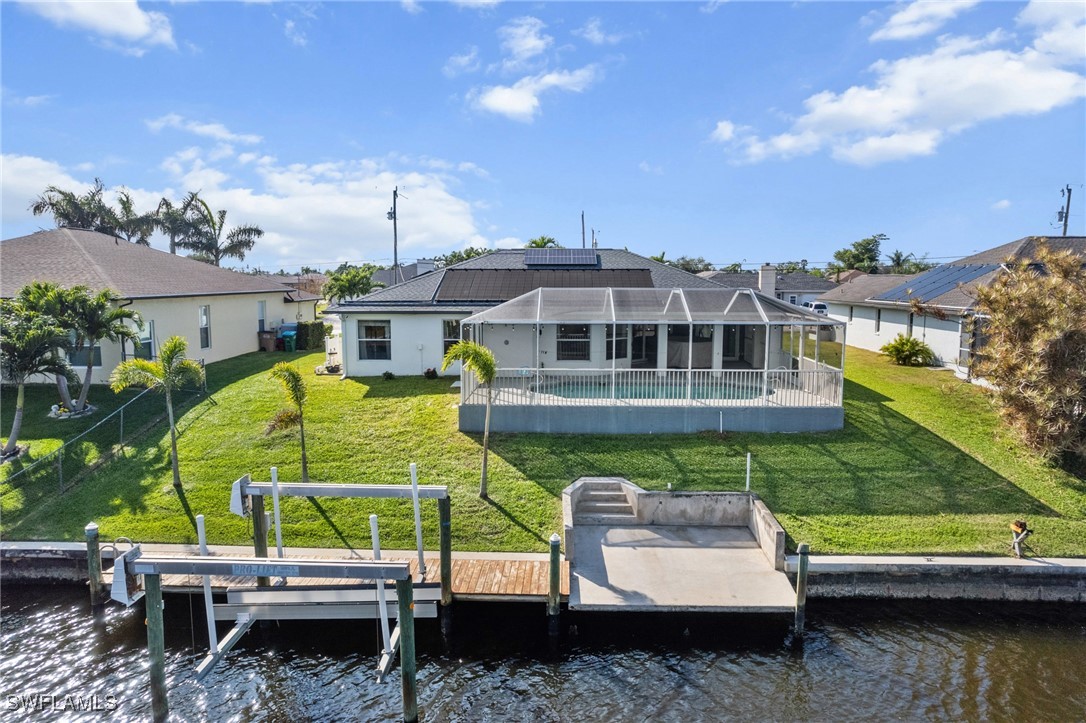 3307 Southwest 2nd Avenue Cape Coral, FL 33914 - Photo 31 of 39 a view of a swimming pool with a patio and a yard