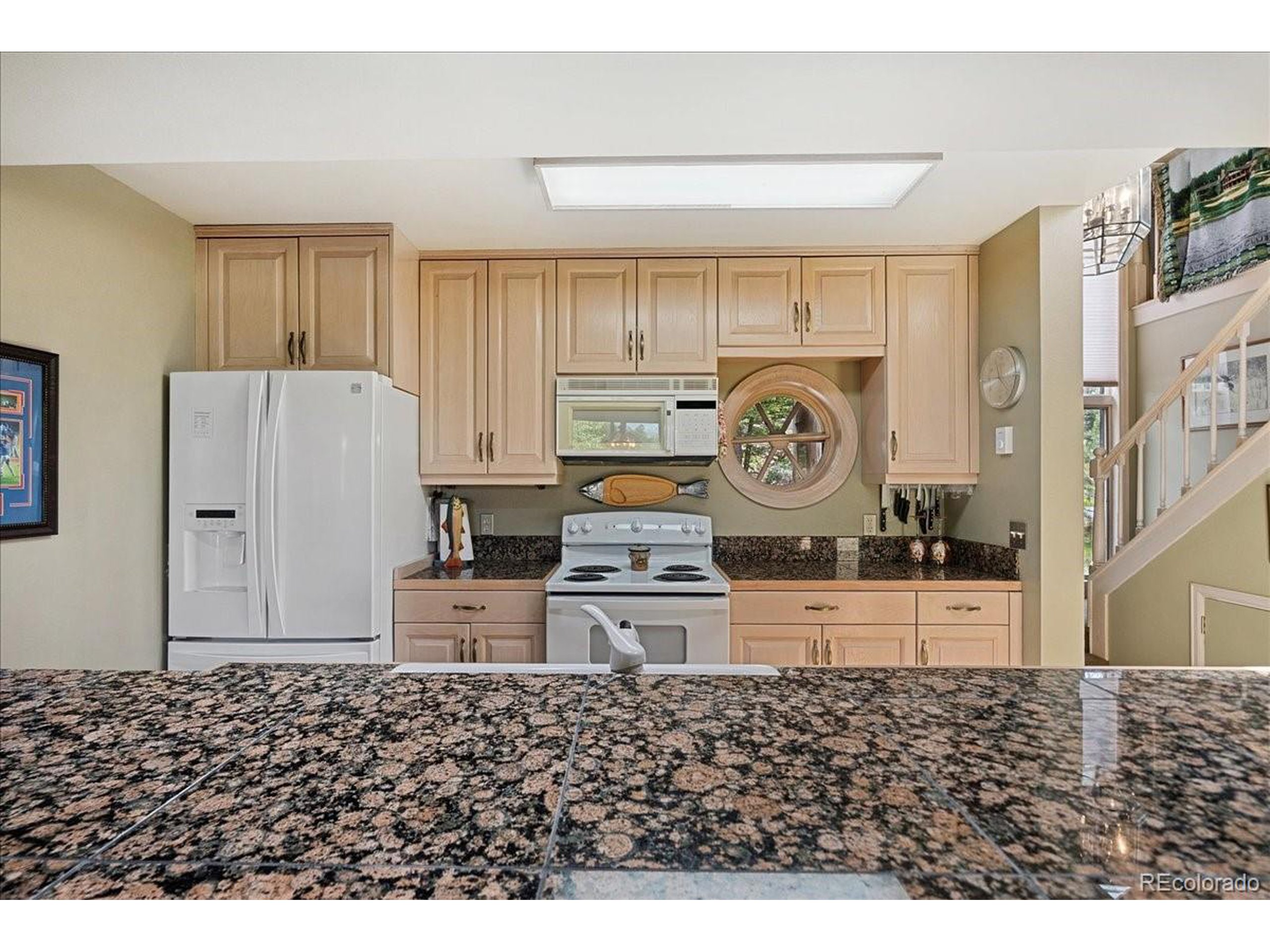40 Three Lks Court Red Feather Lakes, CO 80545 - Photo 14 of 48 a kitchen with a refrigerator and a stove