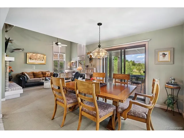 a living room with kitchen island dining table and wooden floor