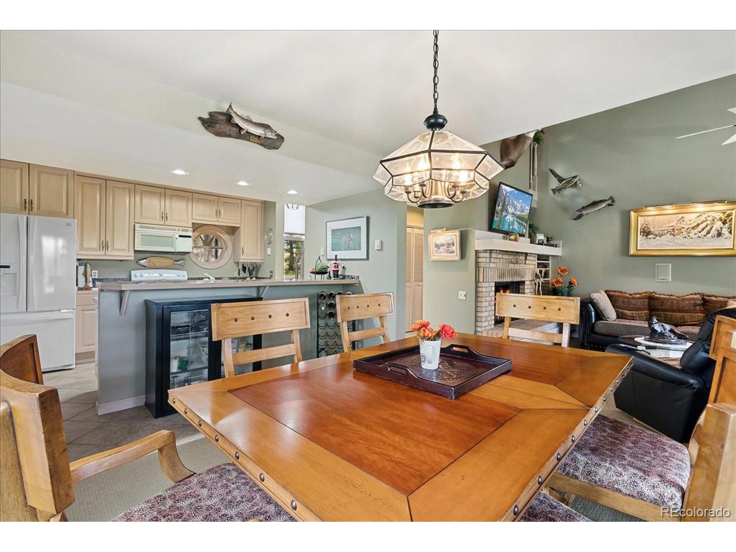 40 Three Lks Court Red Feather Lakes, CO 80545 - Photo 20 of 48 a living room with kitchen island dining table and wooden floor