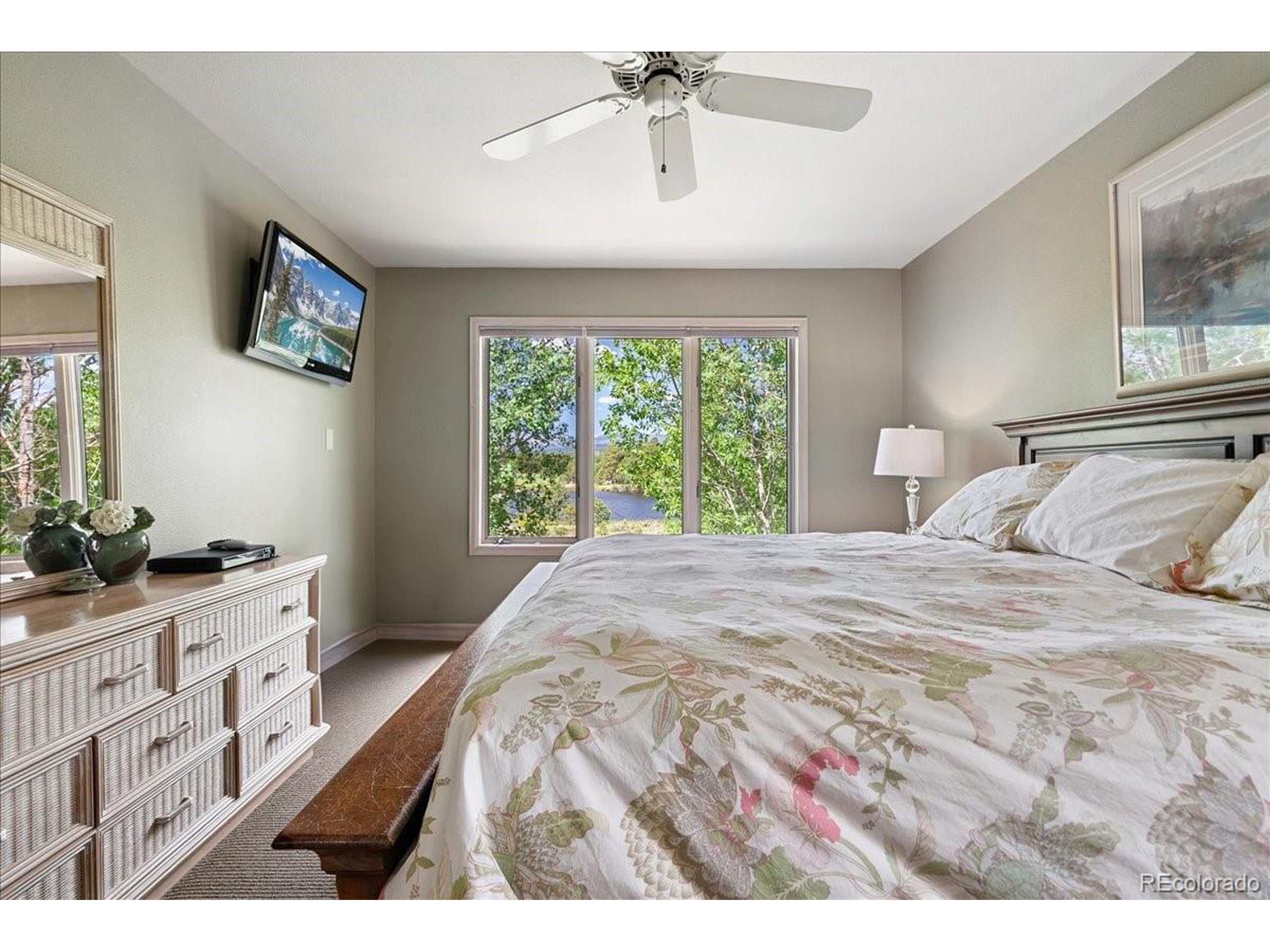 40 Three Lks Court Red Feather Lakes, CO 80545 - Photo 24 of 48 a bedroom with a bed and a chandelier