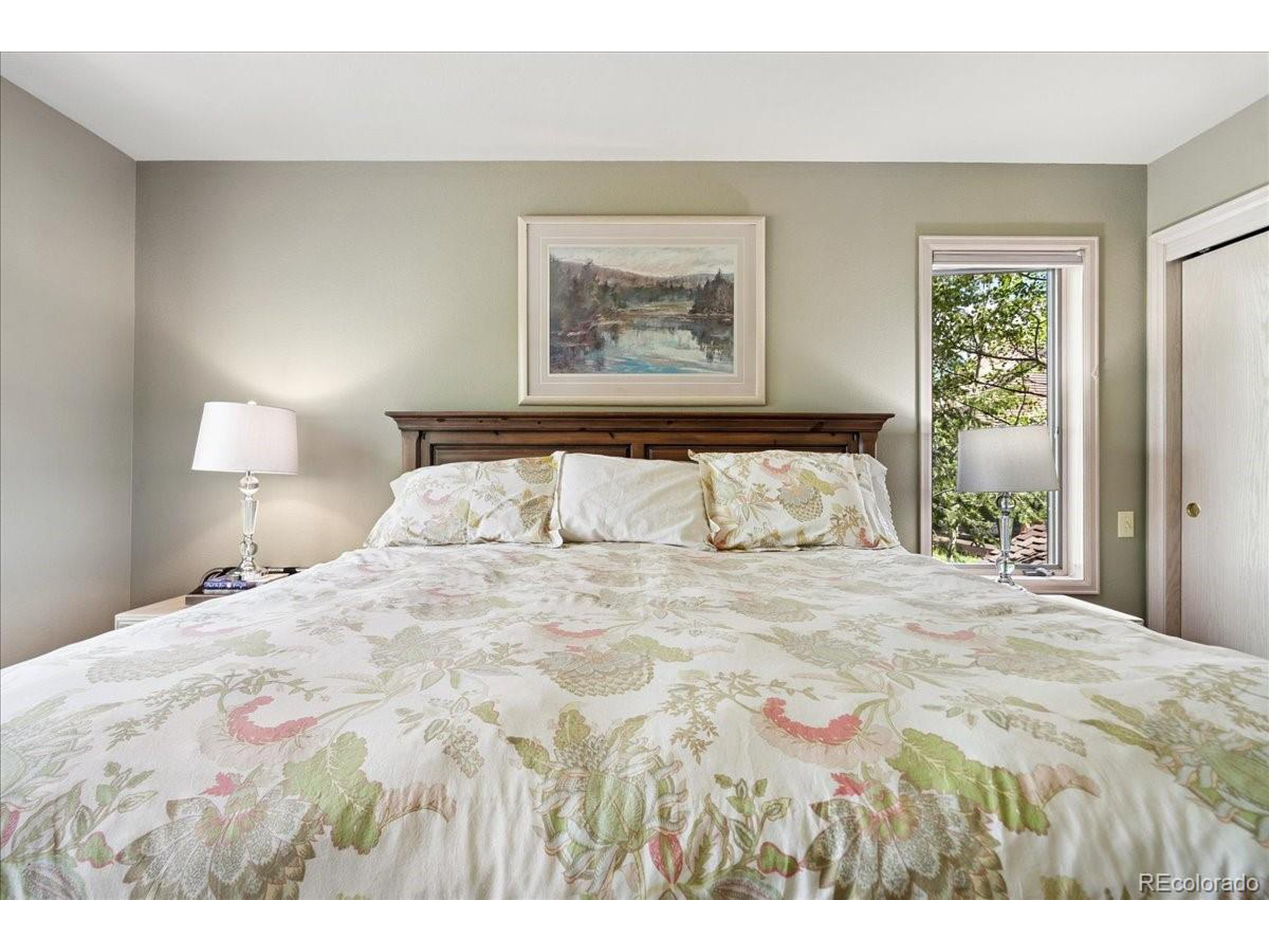 40 Three Lks Court Red Feather Lakes, CO 80545 - Photo 25 of 48 a bedroom with a bed and a painting on the wall