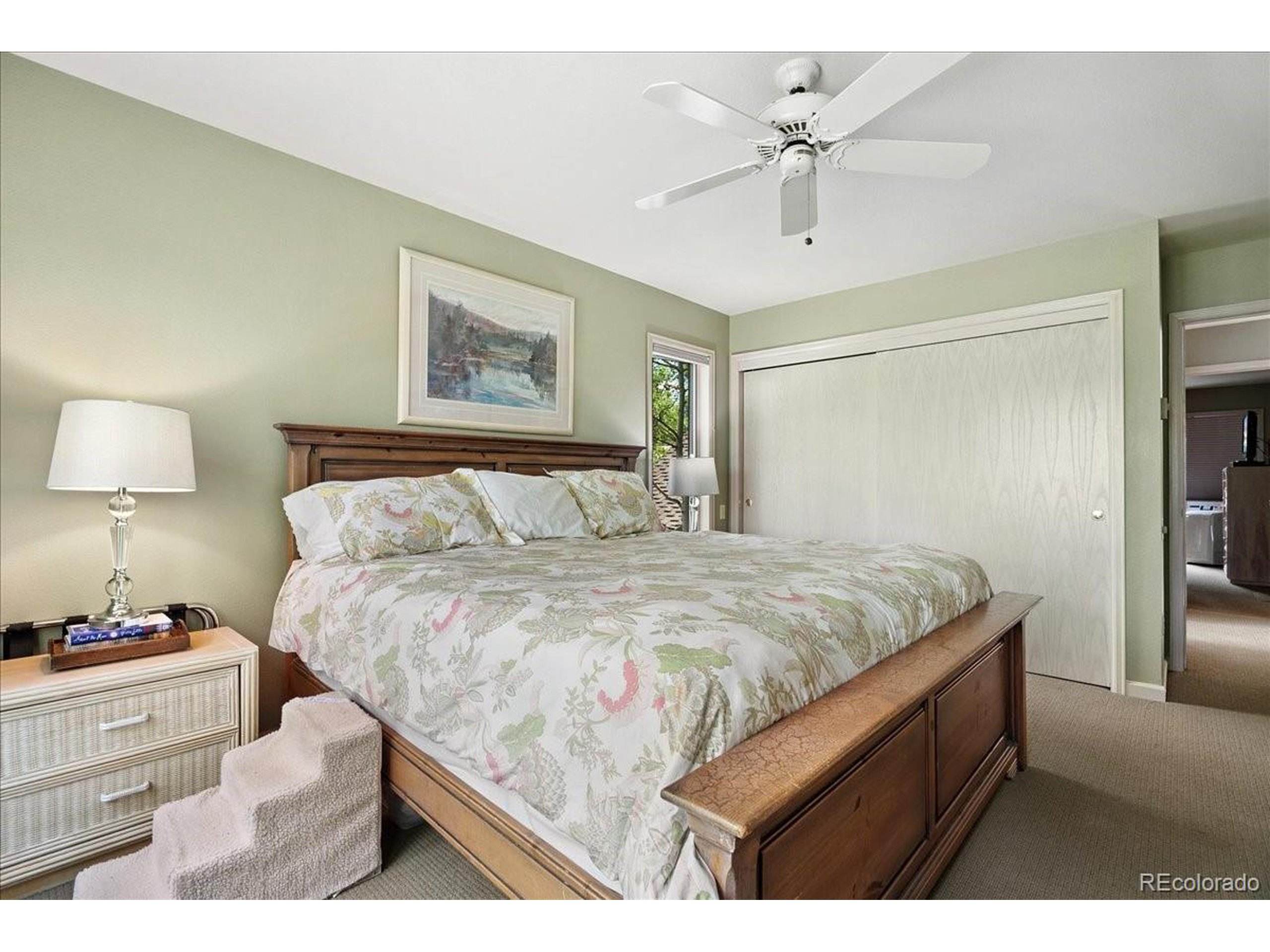 40 Three Lks Court Red Feather Lakes, CO 80545 - Photo 26 of 48 a bedroom with a bed and a ceiling fan with wooden floor