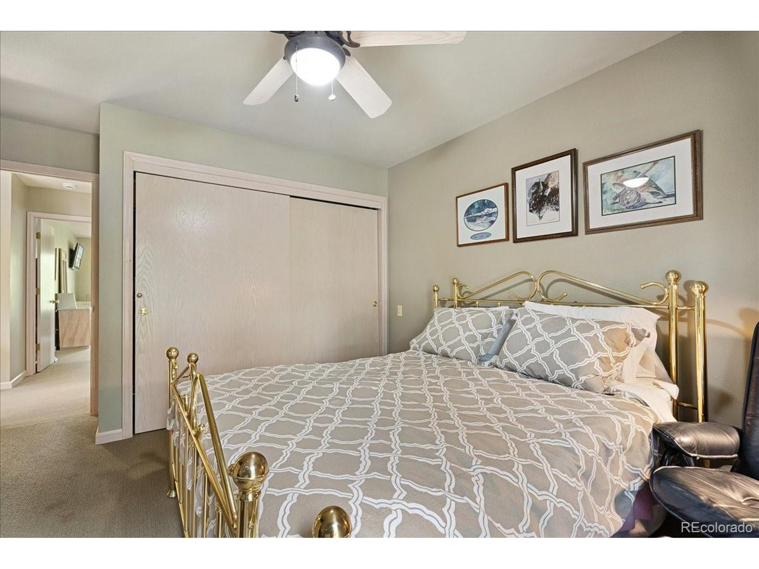 40 Three Lks Court Red Feather Lakes, CO 80545 - Photo 29 of 48 a bedroom with a bed and a chandelier