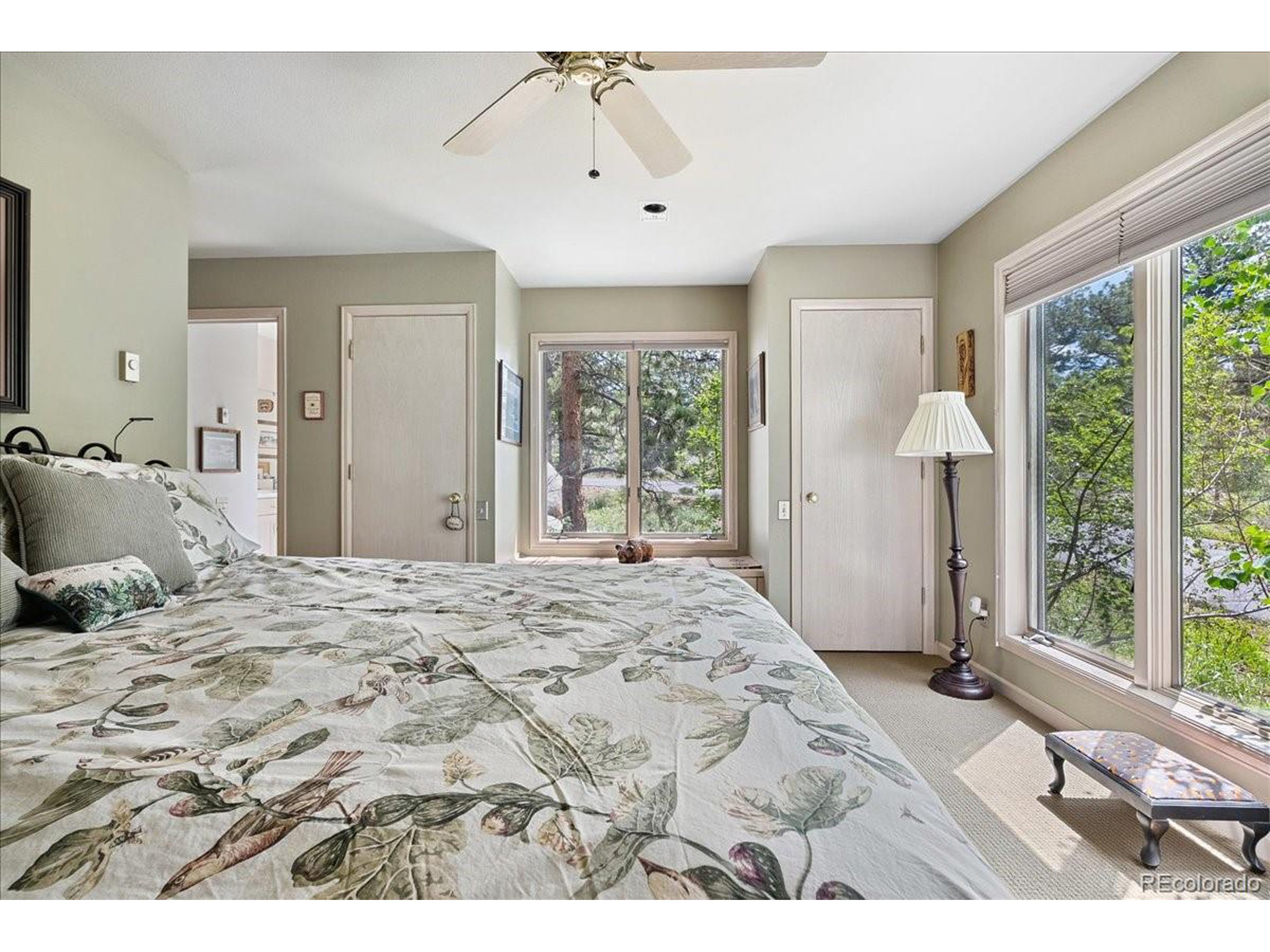 40 Three Lks Court Red Feather Lakes, CO 80545 - Photo 31 of 48 a bedroom with a large bed and wooden floor