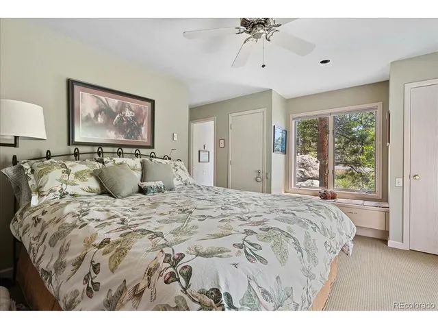 a bedroom with a bed and a painting on the wall