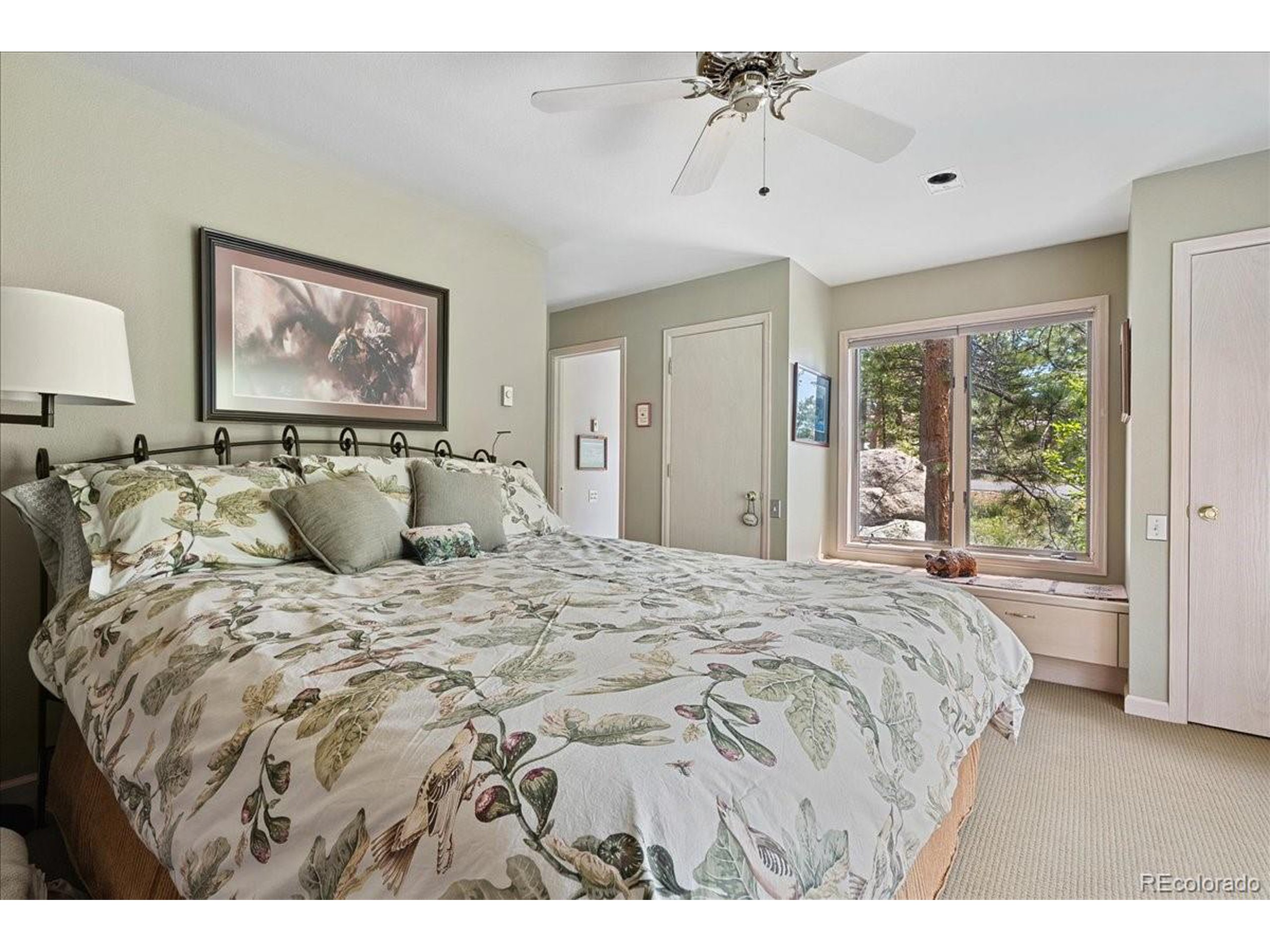 40 Three Lks Court Red Feather Lakes, CO 80545 - Photo 32 of 48 a bed sitting in a bedroom next to a window