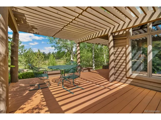 a view of a chairs and table in a patio