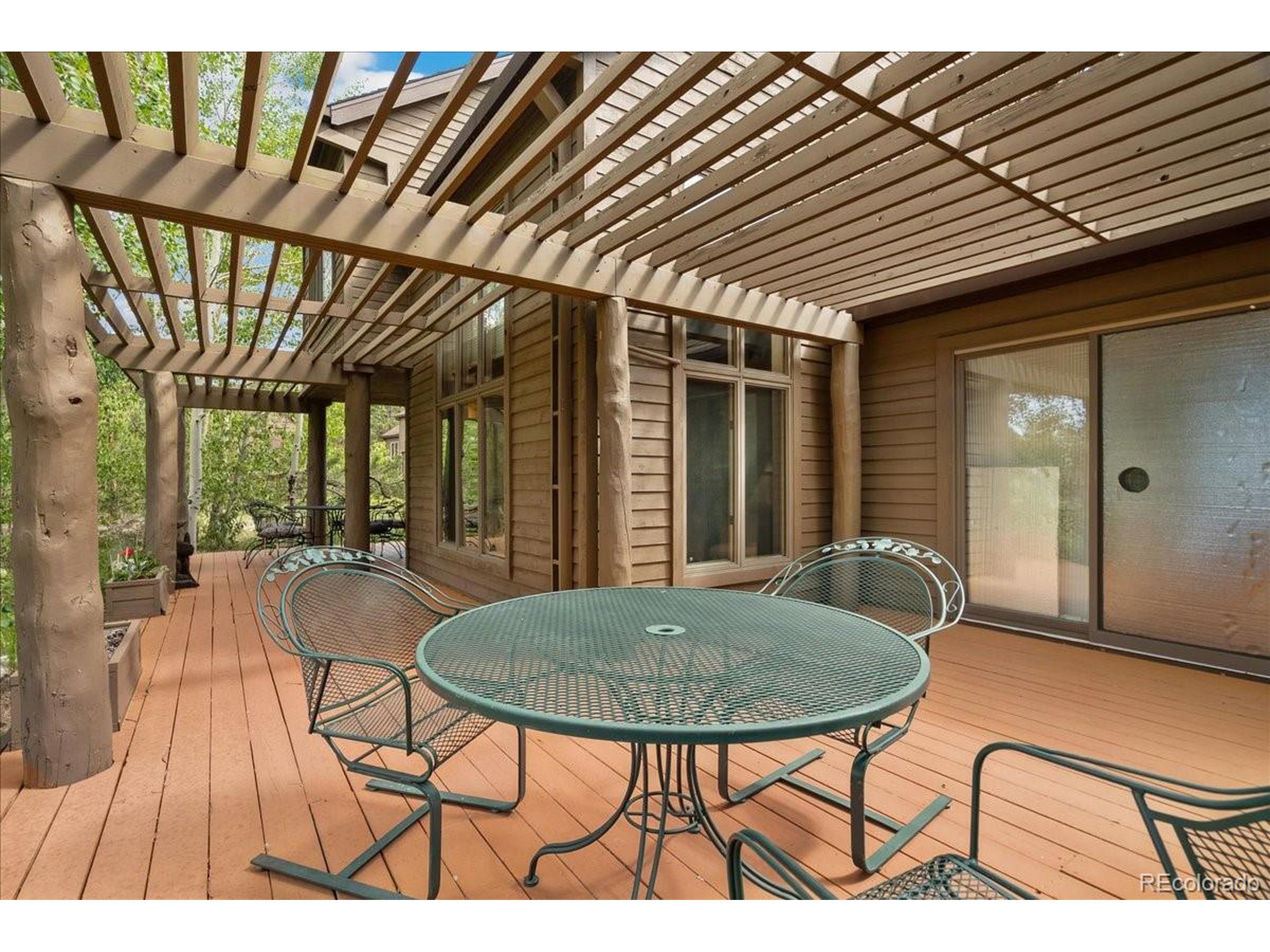 40 Three Lks Court Red Feather Lakes, CO 80545 - Photo 42 of 48 a view of a chairs and table in a patio