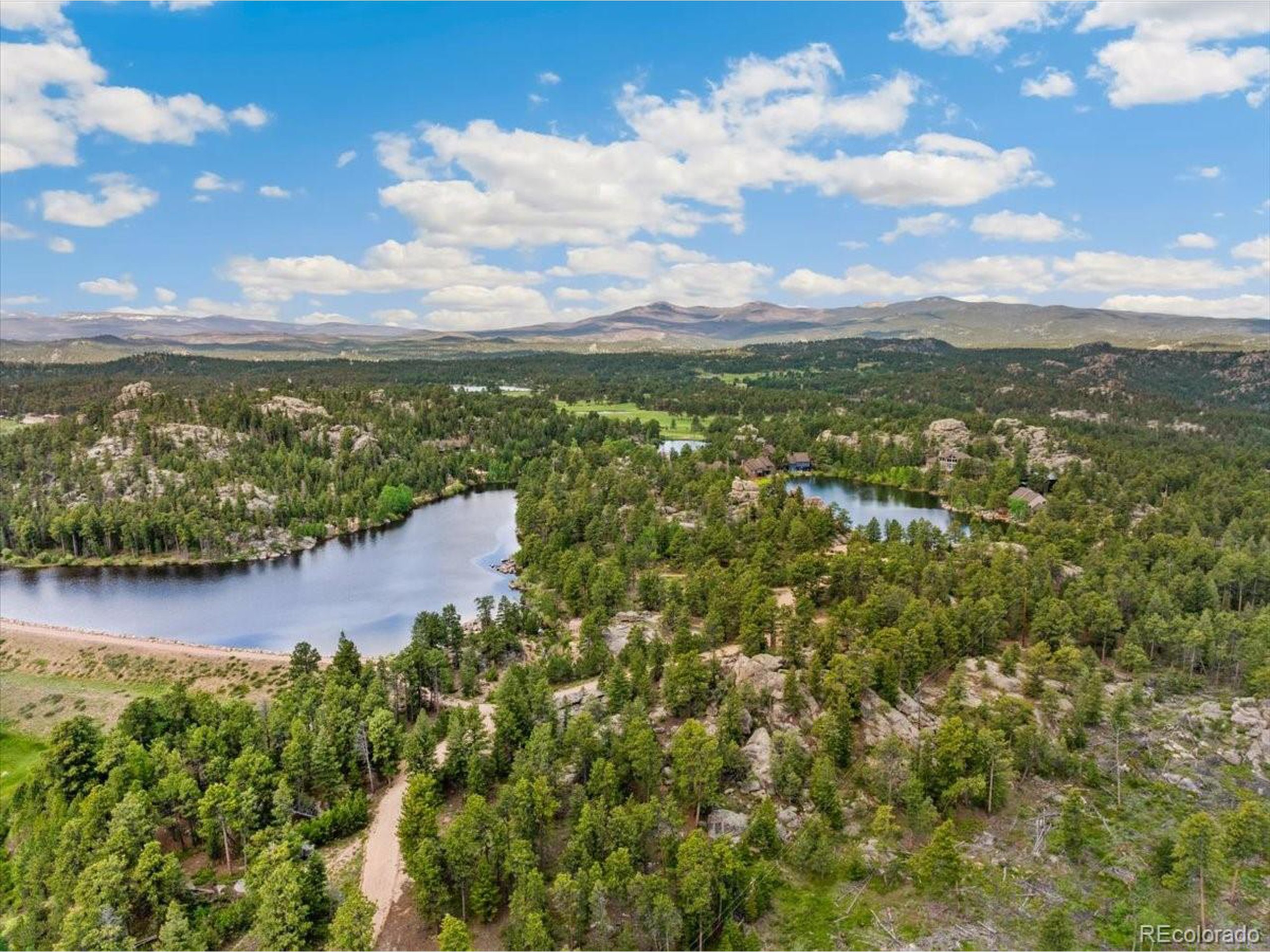 40 Three Lks Court Red Feather Lakes, CO 80545 - Photo 45 of 48 a view of a lake with houses in the back