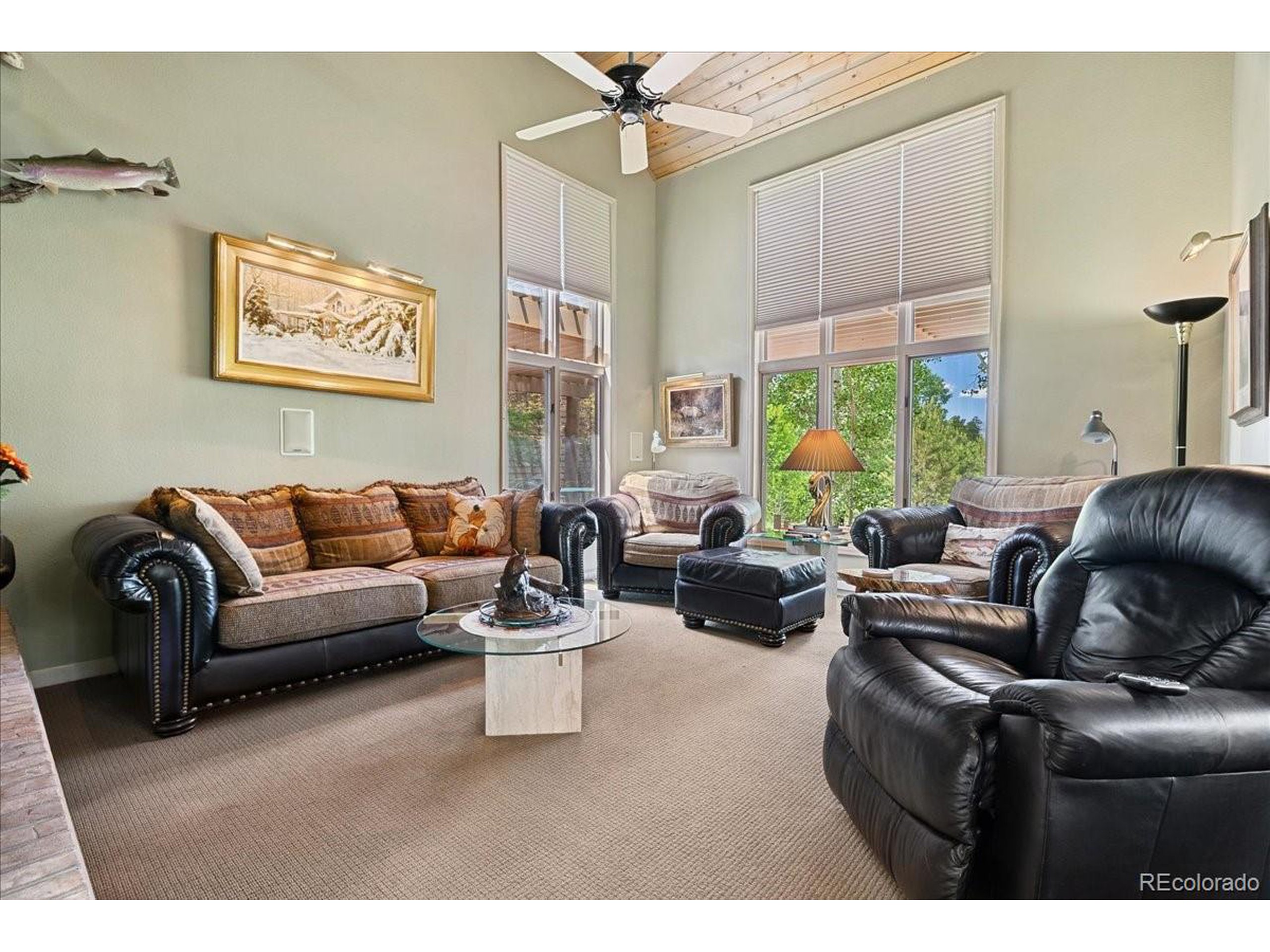 40 Three Lks Court Red Feather Lakes, CO 80545 - Photo 6 of 48 a living room with furniture a chandelier and a large window
