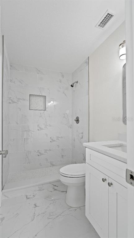 1024 Spindle Palm Way Apollo Beach, FL 33572 - Photo 14 of 50 a bathroom with a toilet sink and shower