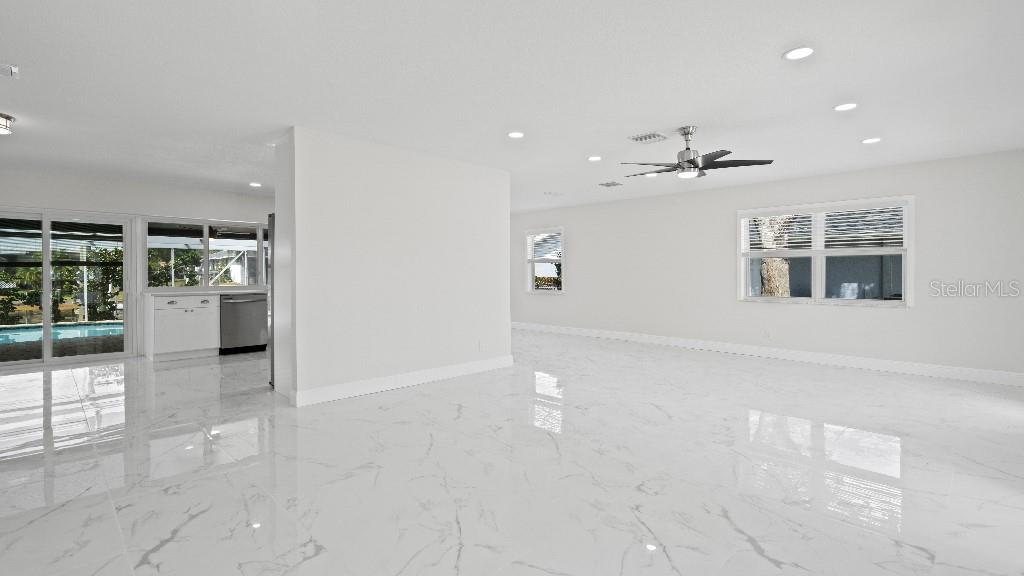 1024 Spindle Palm Way Apollo Beach, FL 33572 - Photo 30 of 50 a view of a livingroom with wooden floor and a kitchen
